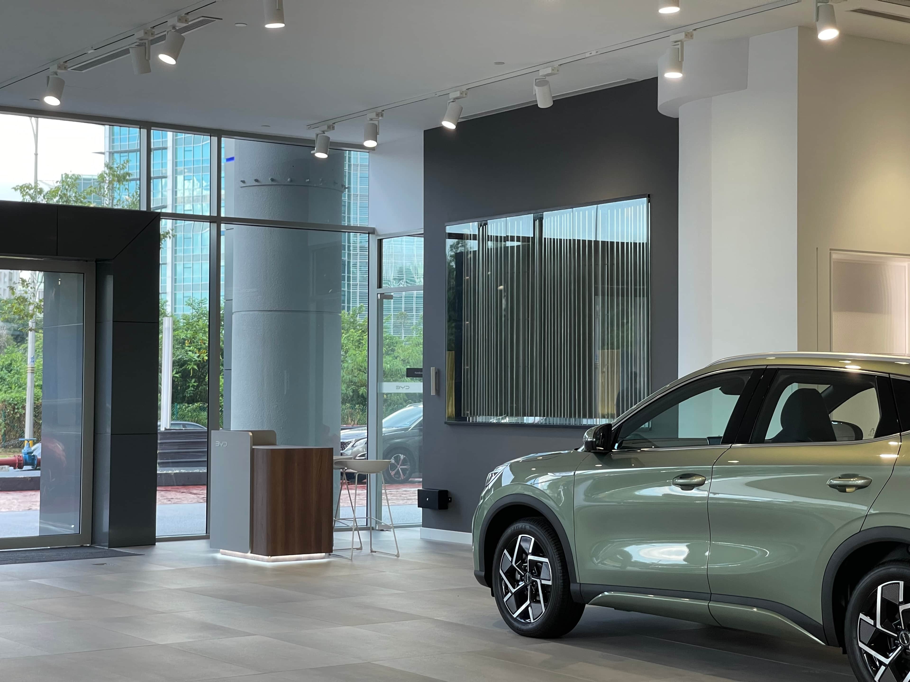 BYD × Nextrend limited edition loudspeakers beside a performance EV