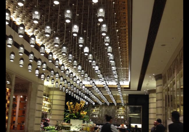 Grand arrival and lobby spaces with low-level background music, tuned to complement the marble, glass and lighting while keeping check-in conversation clear and relaxed.